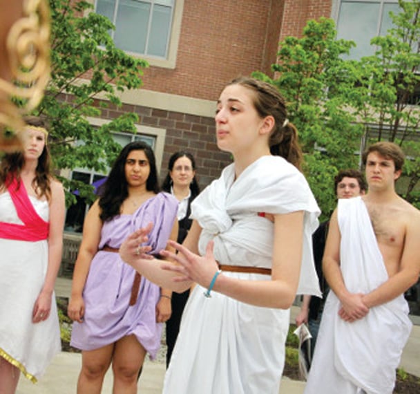 Students wearing togas outside of the DeNaples Center. 